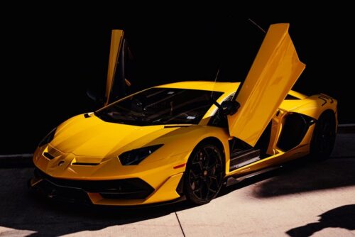 A yellow Lamborghini Aventador with its doors opened