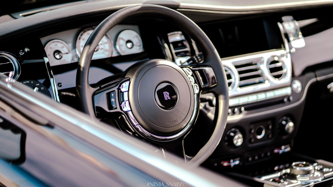 A steering wheel with the Rolls-Royce logo