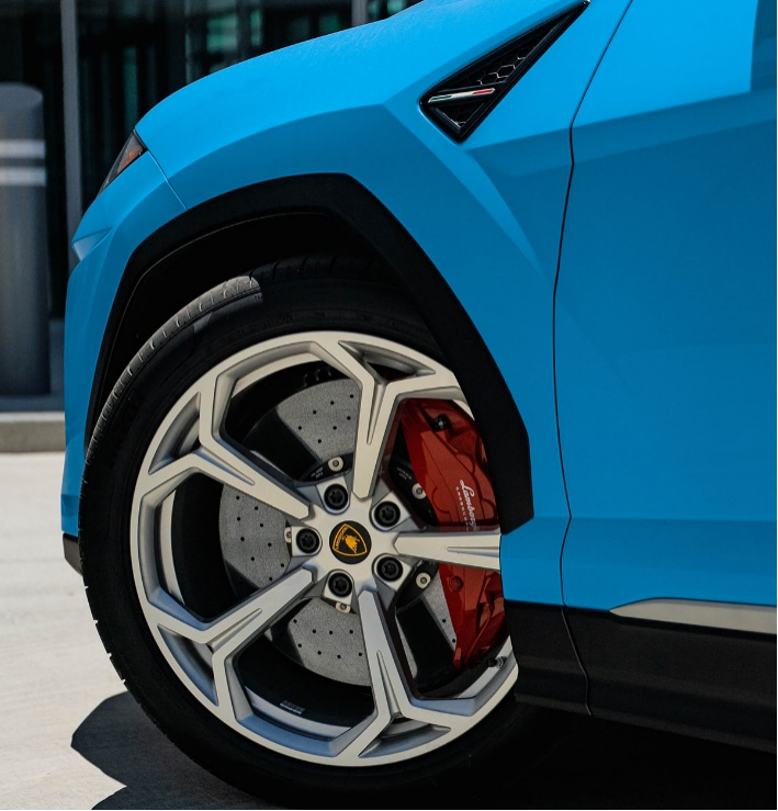  The wheel on a blue Lamborghini Urus. 