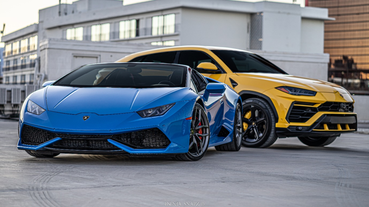 Two Lamborghinis in yellow and blue are parked together.
