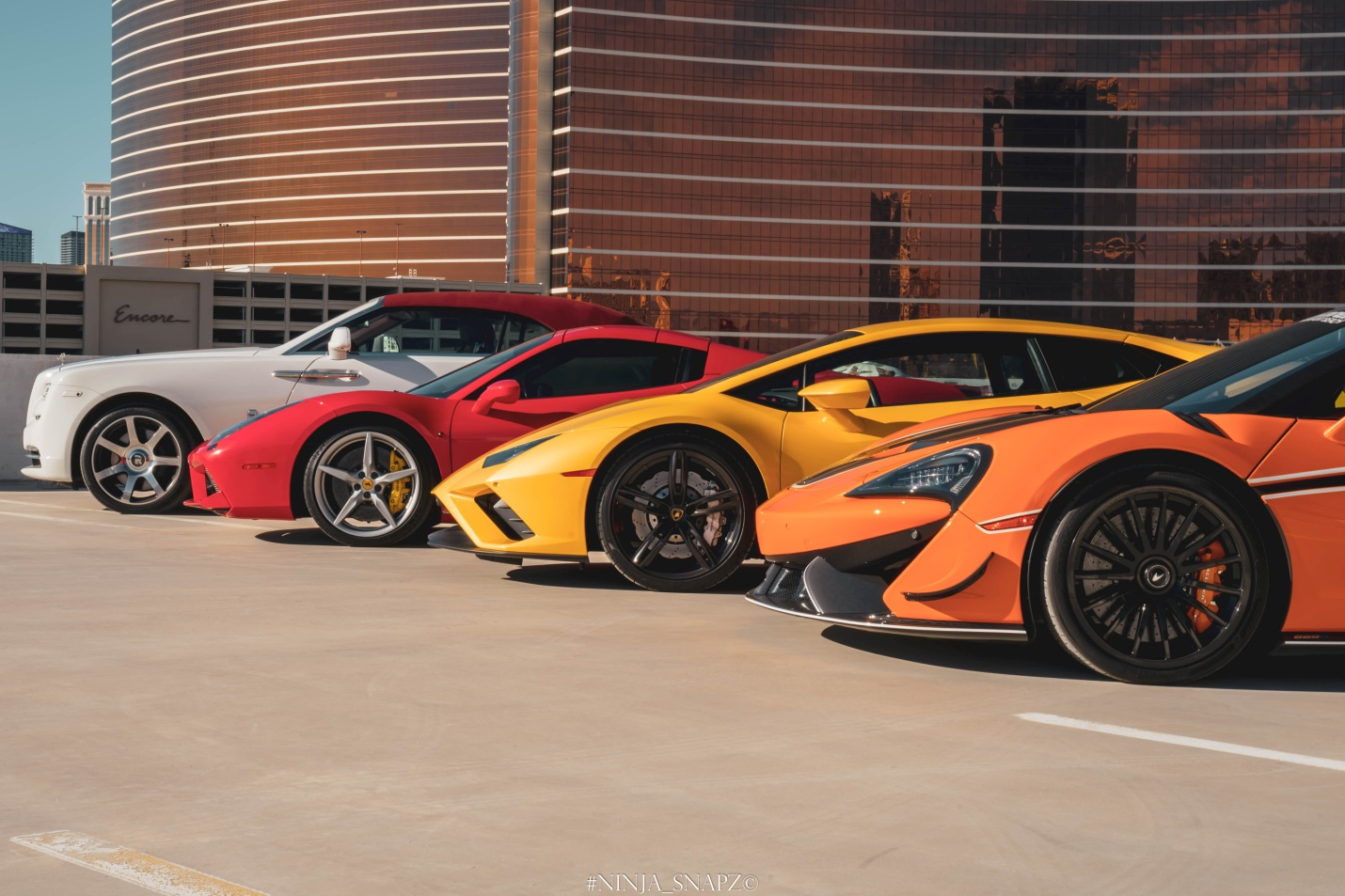 A fleet of expensive rental cars outside LVC Exotic Rentals