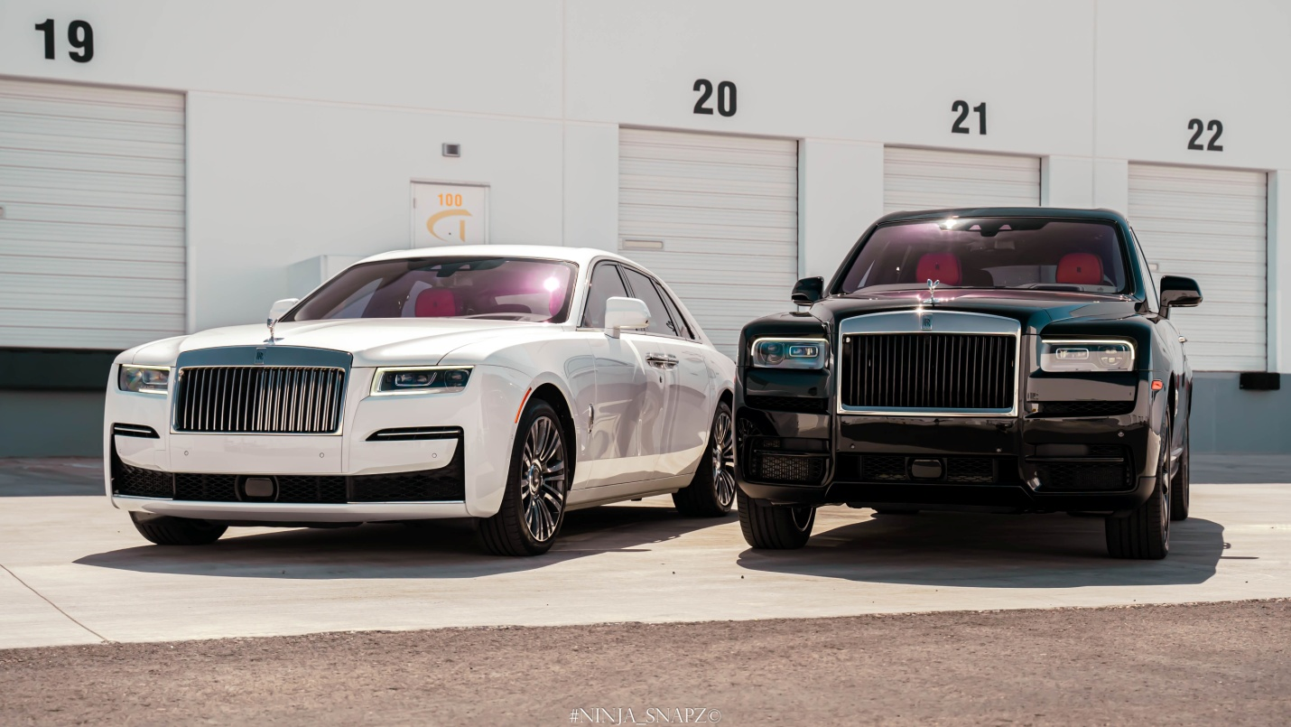 Black and White Rolls Royce parked alongside