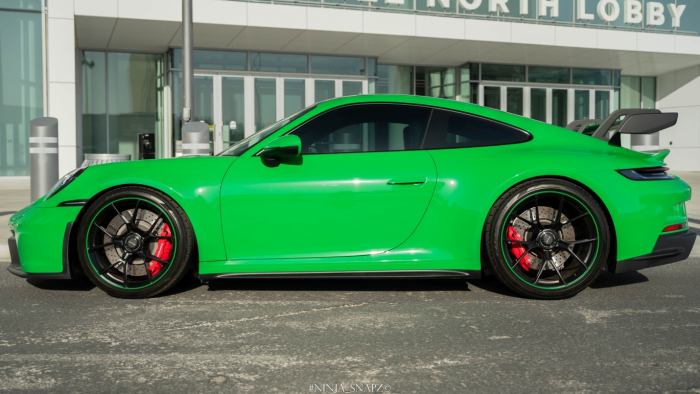 A Porsche GT3 green parked outside.