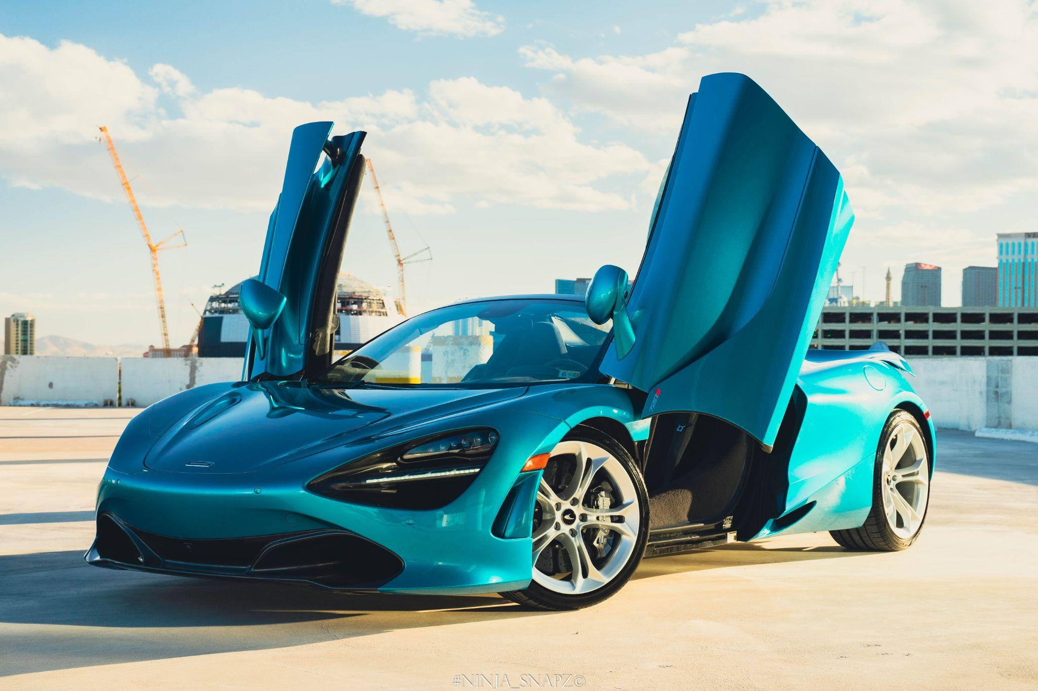  A blue luxury car with its doors open
