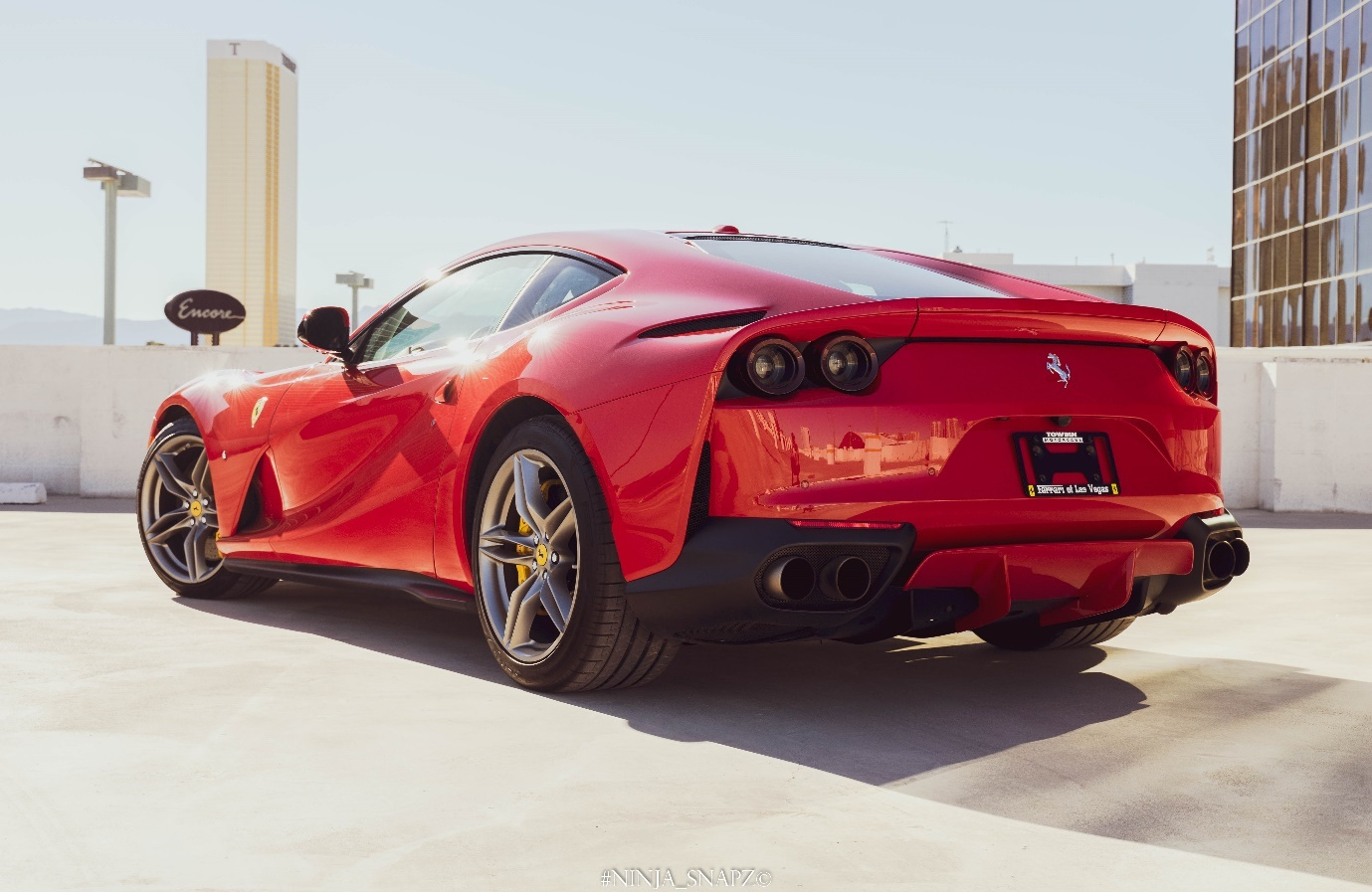 The Ferrari 812 Superfast is parked on the pavement.