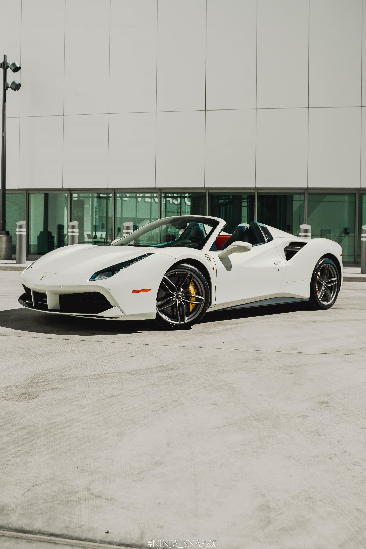 A white Ferrari outside a building